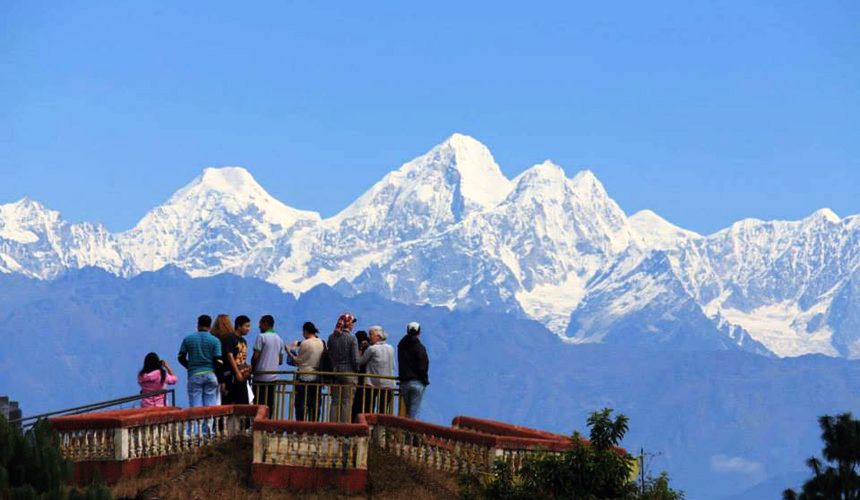 Group of people on view-platform look at Himalayan Mountains