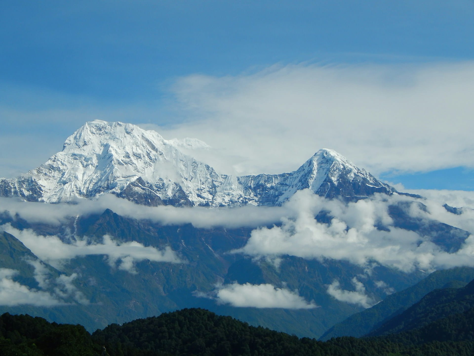 Snowy Mountains Under Hazy Blue Skies