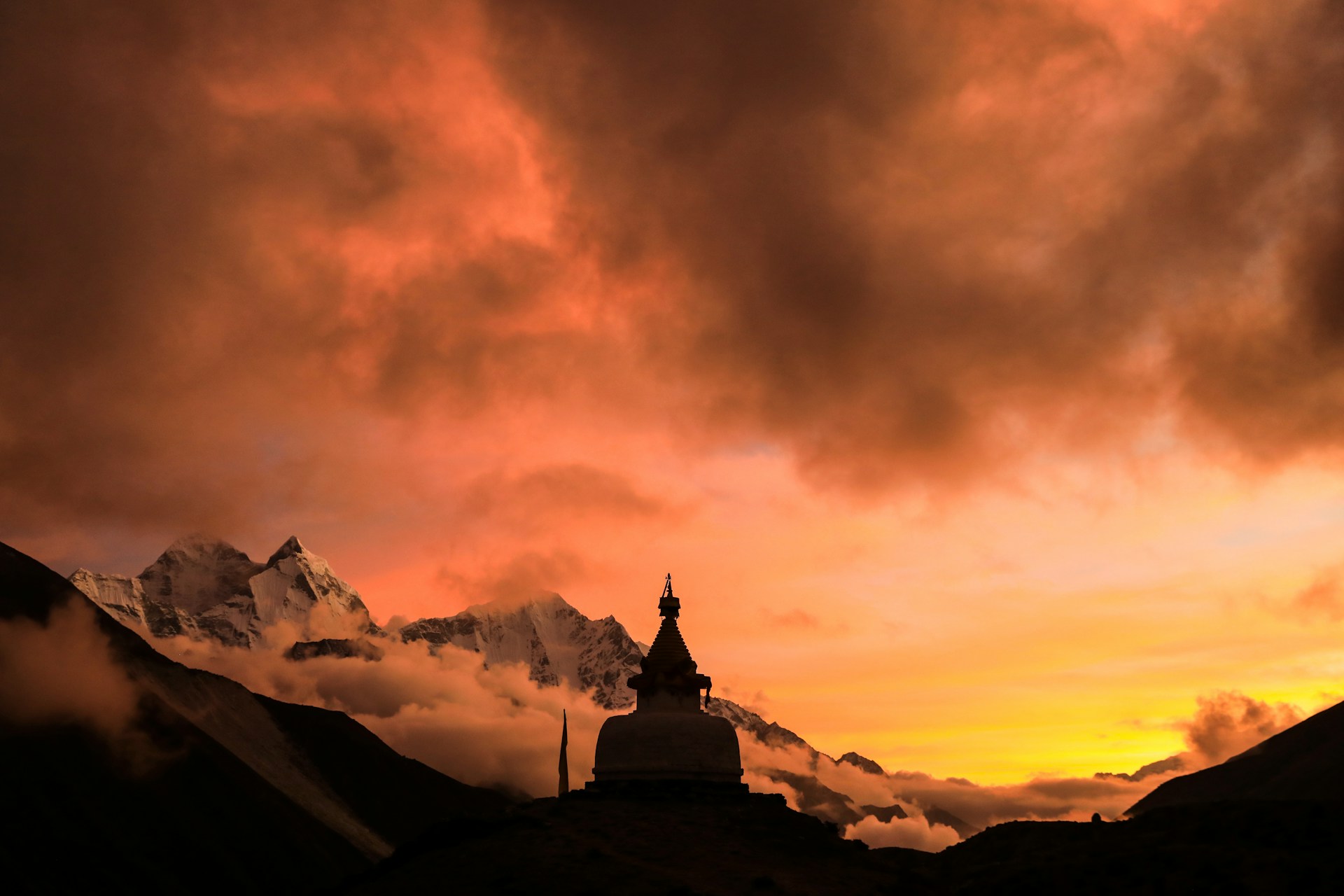 Himalayan Clouds with Orange Skies and Snowy Peaks