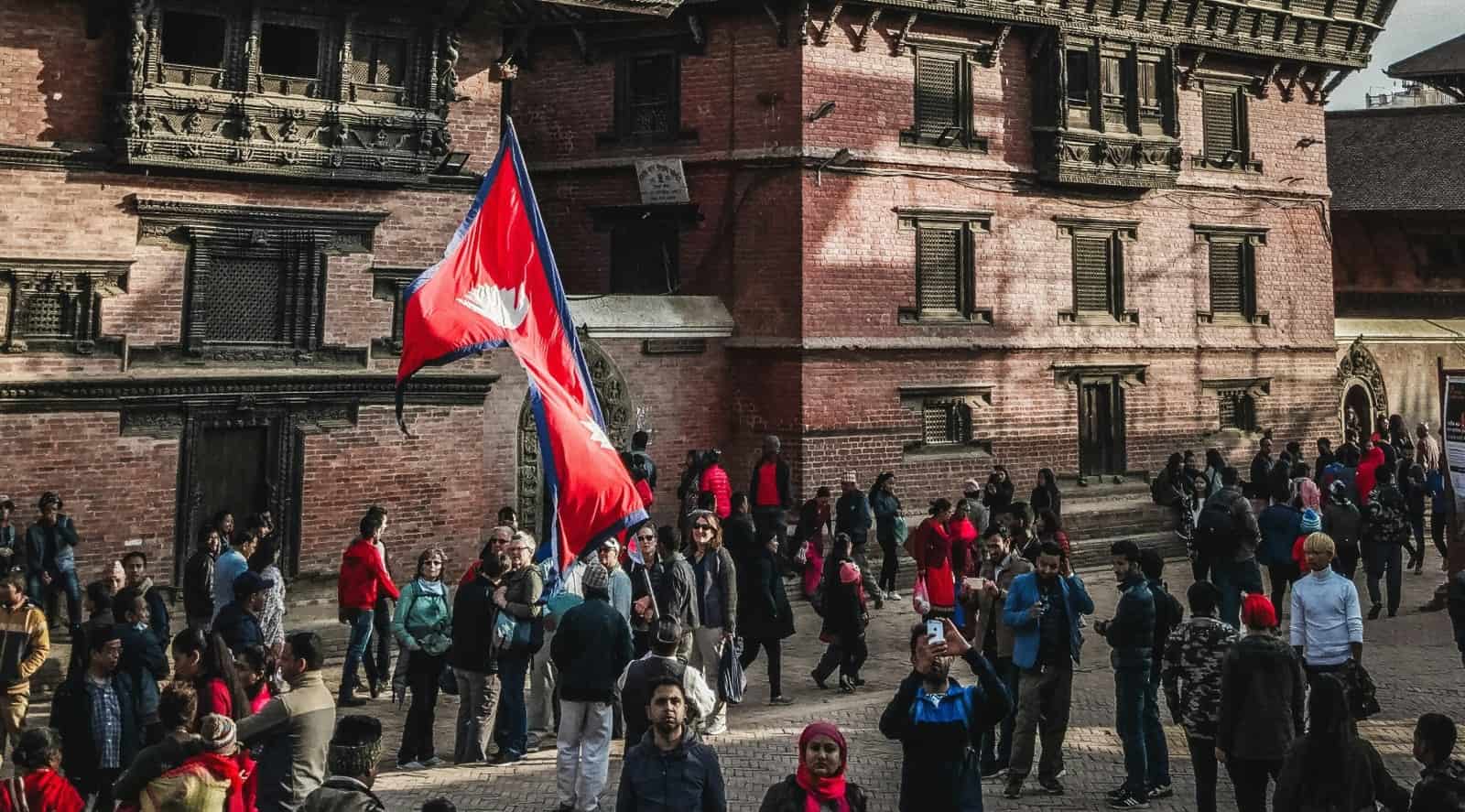 Crowd in city with Nepal flag