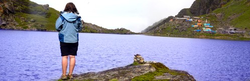 Person watching lake in Himalayas